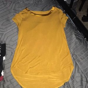 Yellow shirt that flairs out, shiny neck around
